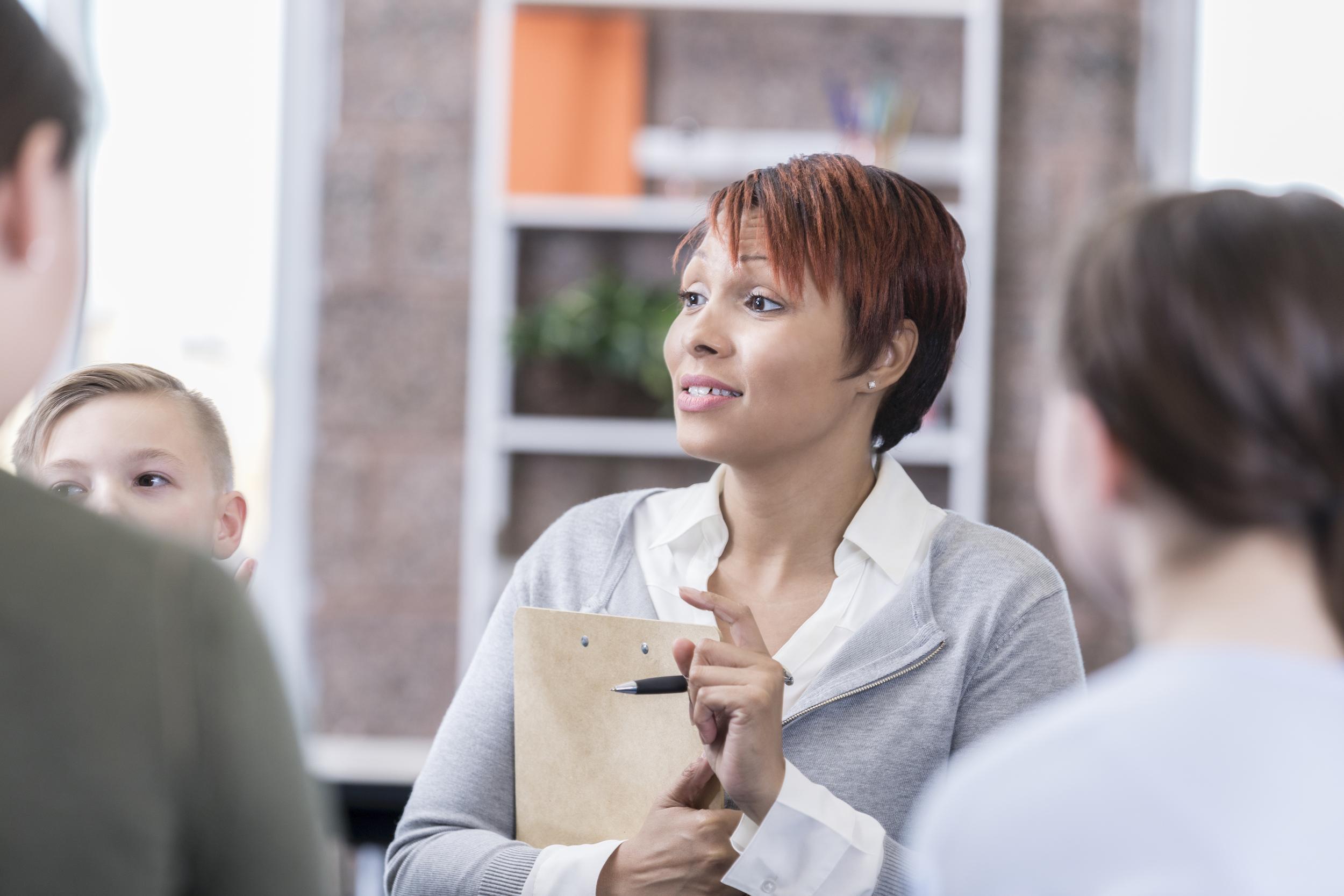 counselor facilitates group therapy session